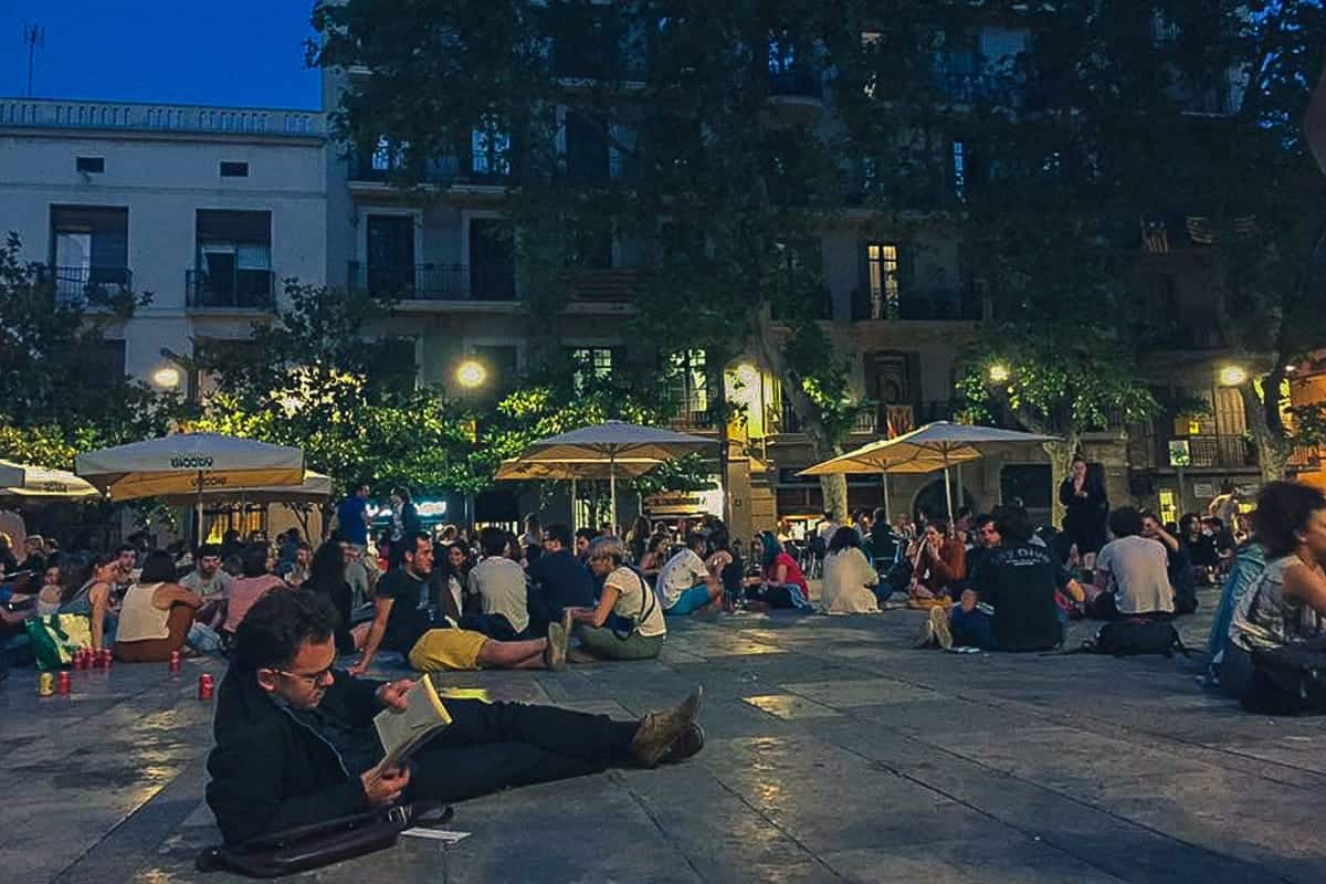 People chilling in the Plaça del Sol, a local experience you'll discover with our Barcelona 2-day itinerary