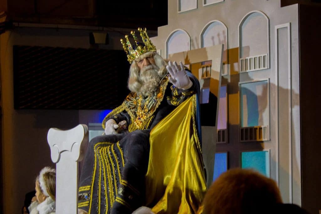 One of the Three Magic Kings waiving at the children during a parade on Christmas in Catalonia
