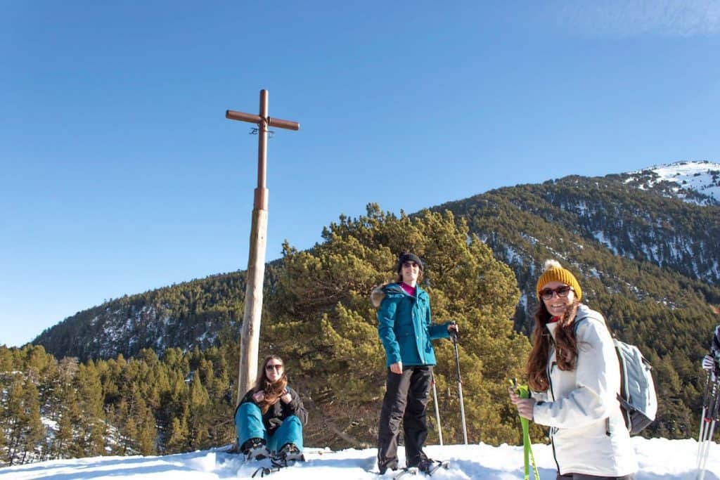 Three people resting in the Creu de Montgarri