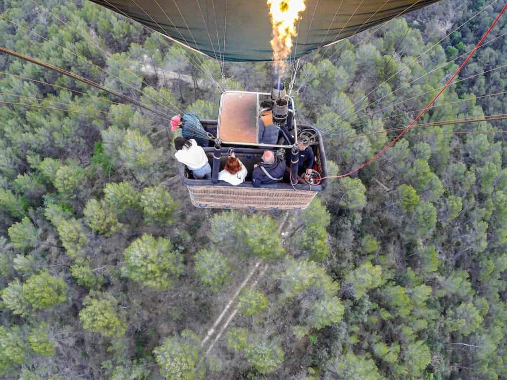 Flying over a forest in a hot air balloon