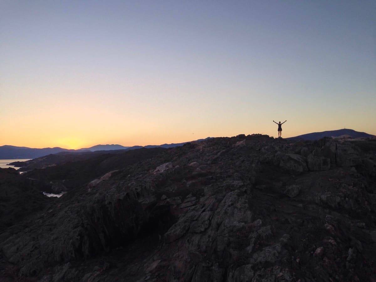 A person enjoying the sunset at Cap de Creus