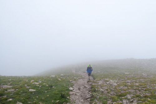 A person in the middle of the fog during the third day of the Cavalls del Vent hike