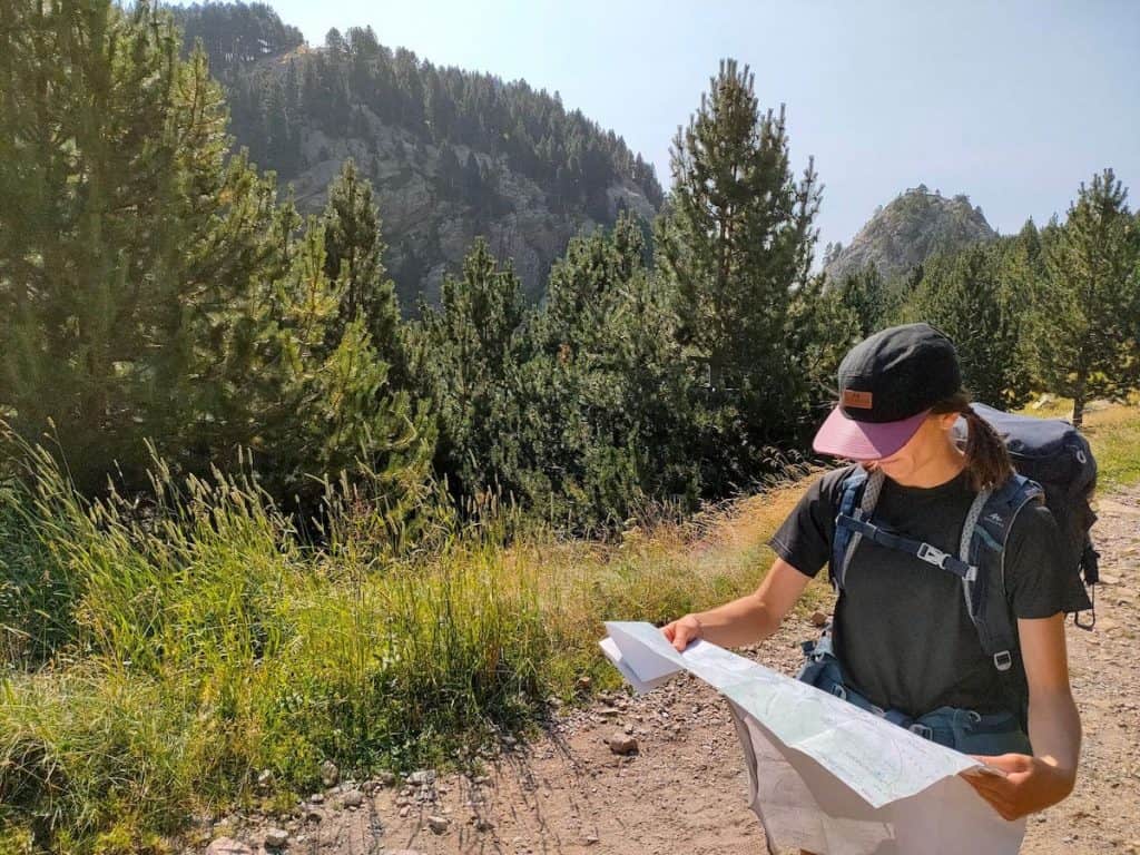 A person checking a map in the middle of a hike