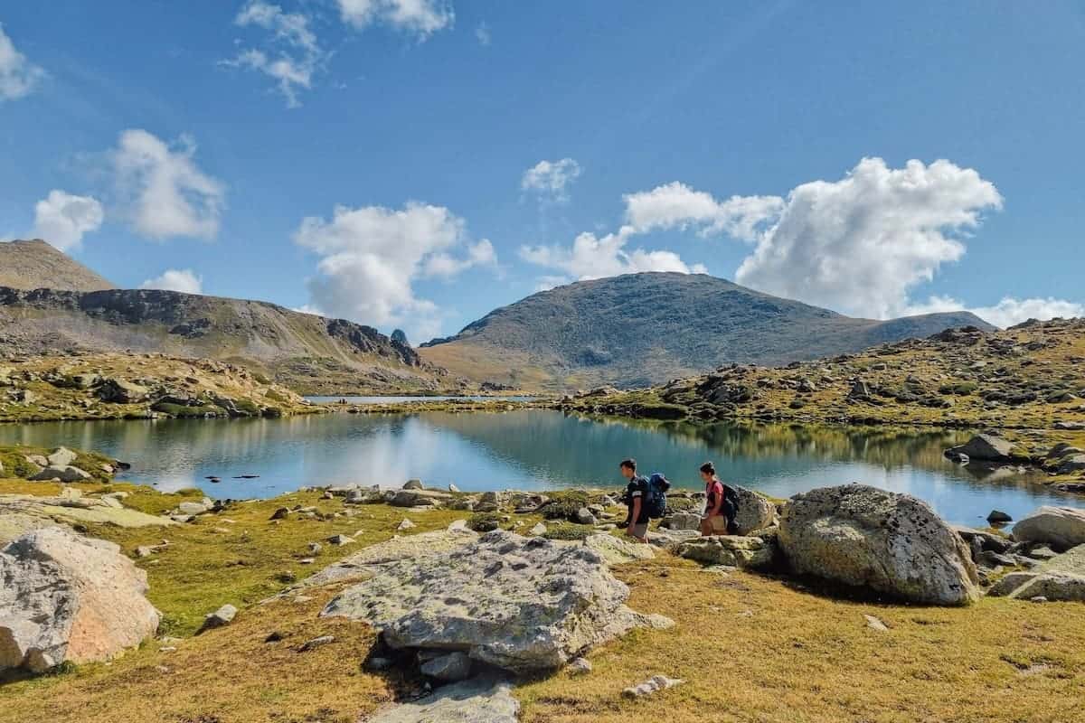 Two hikers walking the Estanys Amagats hiking route