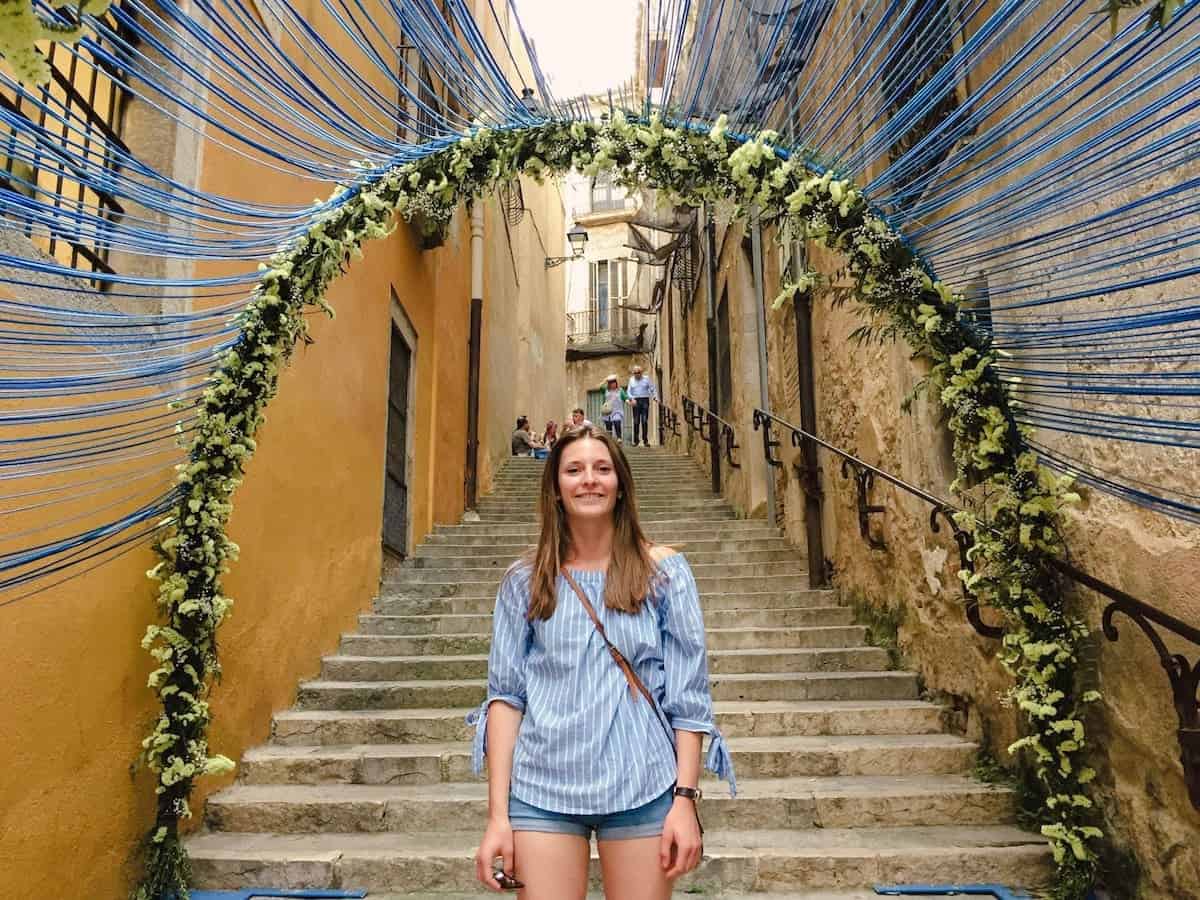 A person standing in front of a floral display at the Temps de Flors Festival