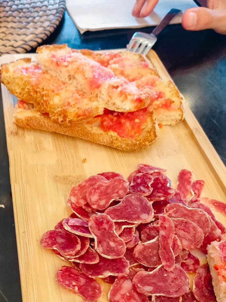 Sliced fuet with pa amb tomàquet (tomato bread)