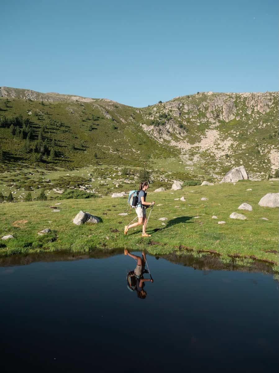 A hiker encountering a horse in the Estanys Amagats route