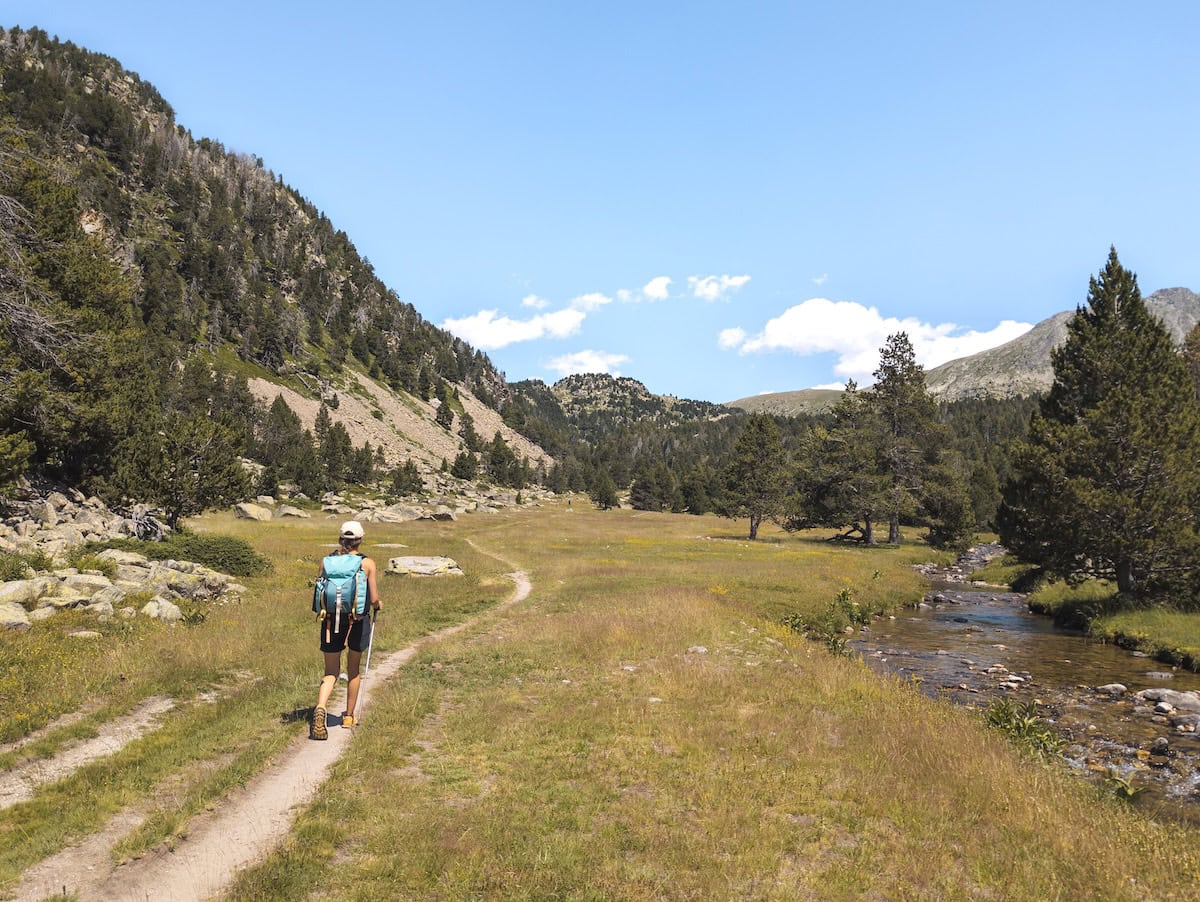 Crossing a beautiful green meadow on the first day of the Coronallacs hike