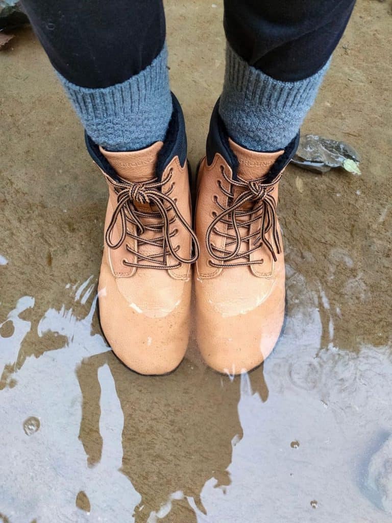 A pair of hiking boots immersed in water