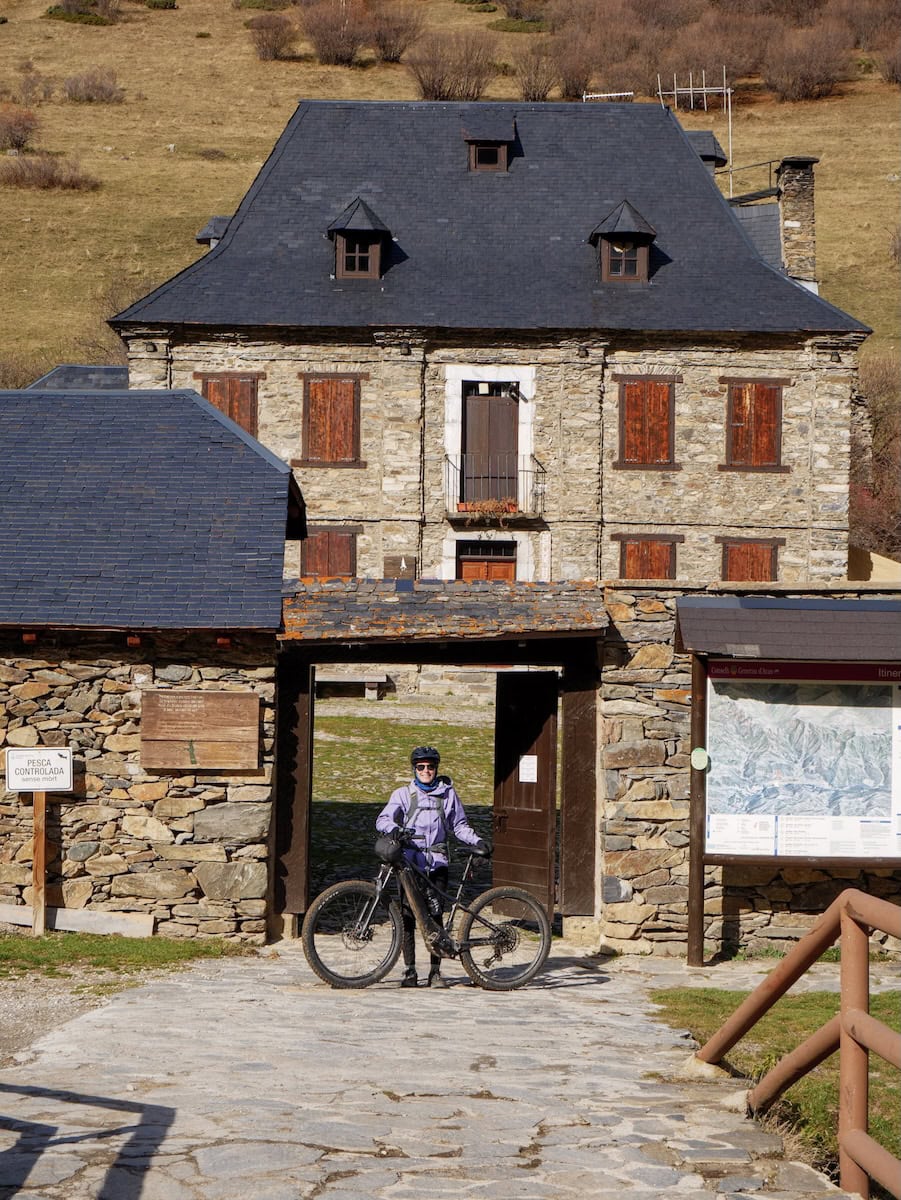 A person taking a break from cycling at Montgarri Sanctuary in the Pyrenees of Lleida