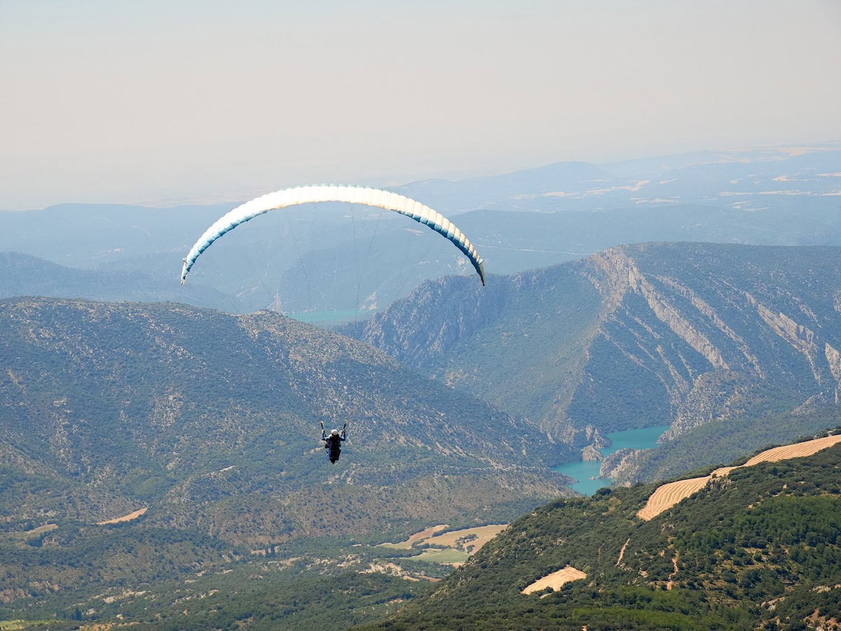 A person paragliding in Àger (Terres de Lleida)