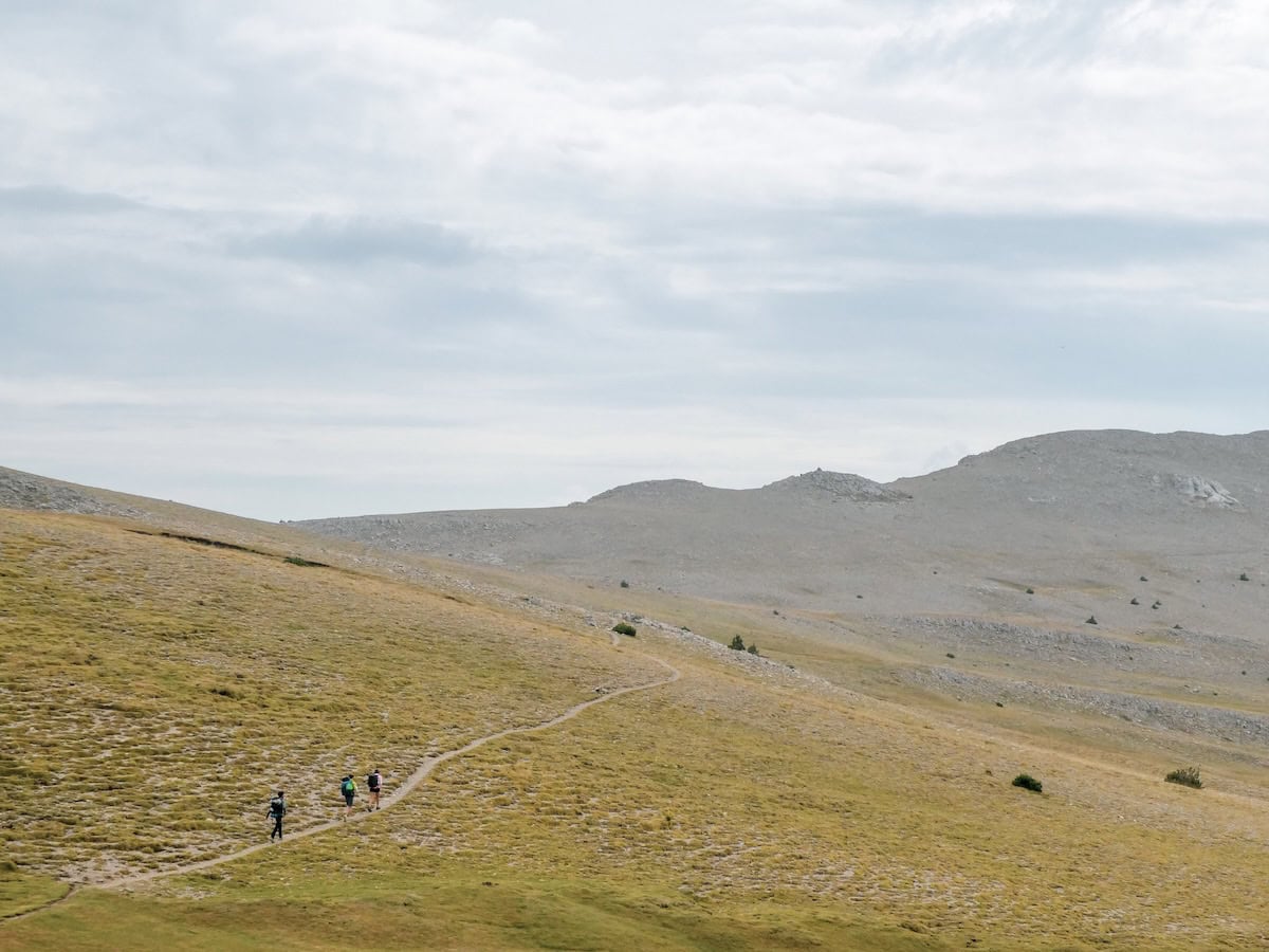 Three people hiking the Pas dels Gosolans