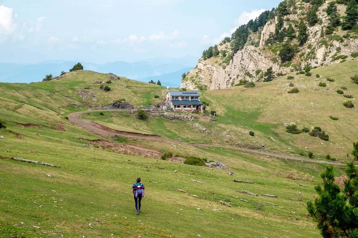 A hiker walking to the Prat d'Aguiló mountain hut