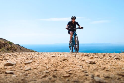 A person cycling to the top of Puig d'en Grau in Roses