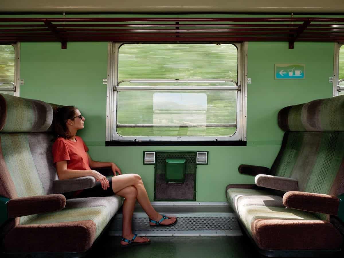 A person sitting at the Tren dels Llacs