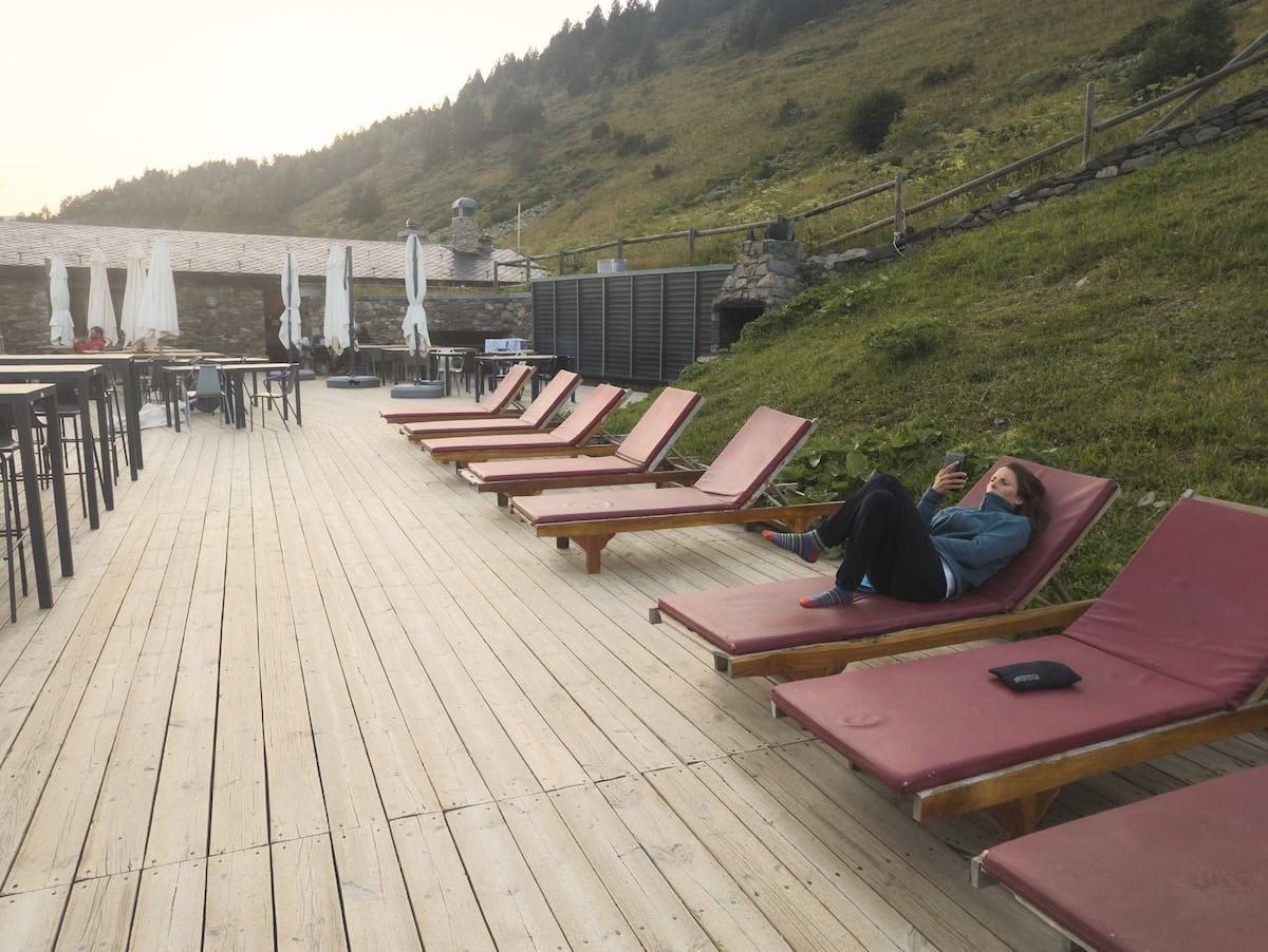 A person reading on the terrace of the Sorteny hut